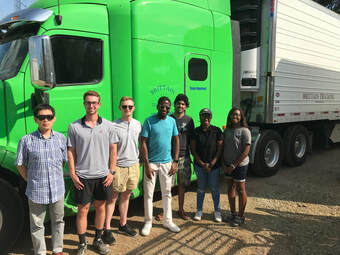 students in front of a big rig